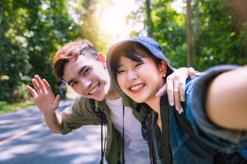 Group of young people with backpacks traveling together