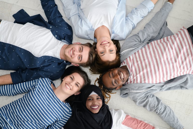 Diverse group of people lying on floor, top view